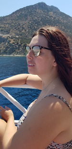 Woman with sunglasses on boat in sea