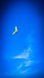 Low angle view of kite flying against blue sky