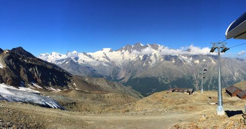 Scenic view of snowcapped mountains against clear blue sky