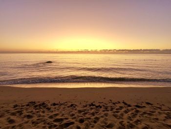 Scenic view of sea against clear sky during sunset