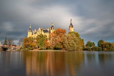 Panoramic view of trees and buildings against sky