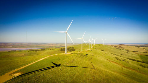 Windmill on field against sky