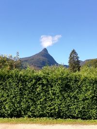 Scenic view of mountains against blue sky