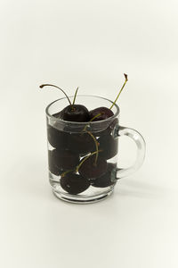 Close-up of wineglass on table against white background