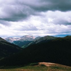 Scenic view of mountains against cloudy sky