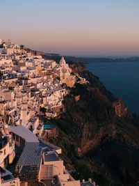 High angle view of townscape by sea against sky