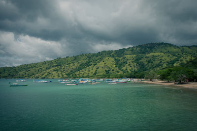 Scenic view of sea and mountains against sky