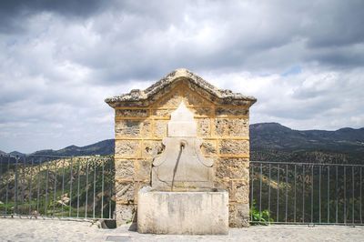 View of fountain against cloudy sky