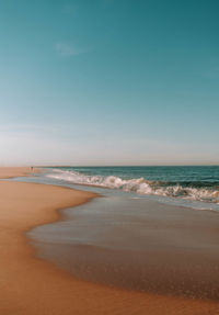 Scenic view of beach against clear sky