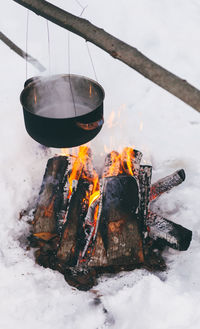 High angle view of bowl over campfire during winter