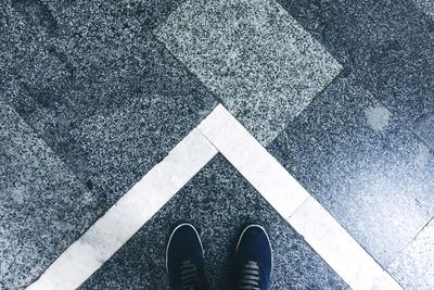 Low section of man standing on floor