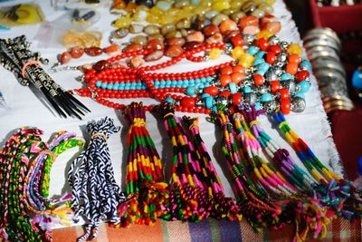 High angle view of multi colored souvenirs arranged at market stall