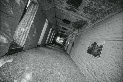 Empty narrow pathway along walls