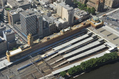 High angle view of railroad tracks amidst buildings in city