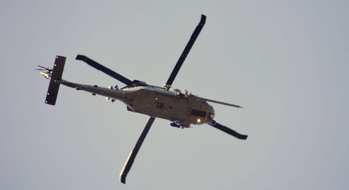 Low angle view of airplane flying against clear sky