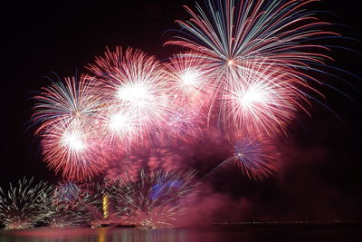 Low angle view of firework display at night