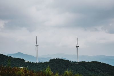 Scenic view of mountains against cloudy sky