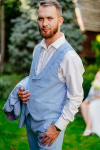 Portrait of young man standing outdoors