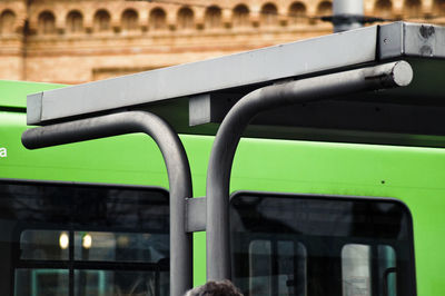 Cropped image of metallic structure against bus