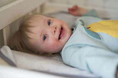 Close-up of cute baby boy sleeping on bed at home