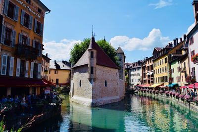 Canal passing through buildings in city