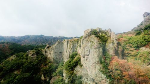 Low angle view of rocky mountain against sky