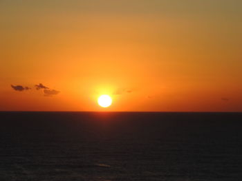 Scenic view of sea against romantic sky at sunset