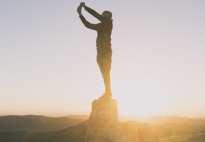 Man standing on mountain against sky