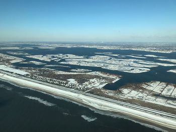 Aerial view of sea against sky during winter