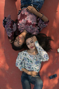 High angle view of young women lying on floor