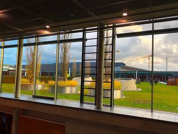 View of built structure against sky seen through window