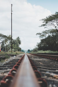 Surface level of railroad tracks against sky