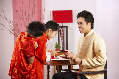 Father greeting sons during festival