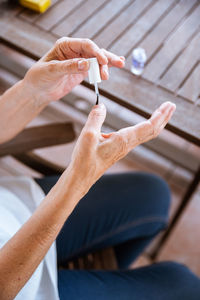 High angle view of woman applying nail polish