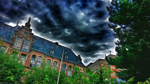 Low angle view of building against cloudy sky