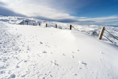 Scenic view of snow covered mountains against sky