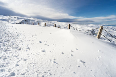 Scenic view of snow covered mountains against sky