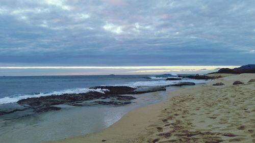 Scenic view of sea against cloudy sky