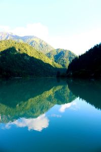 Scenic view of lake by mountains against sky