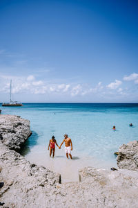 People on beach against sky