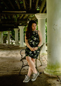 Full length of young woman standing in park