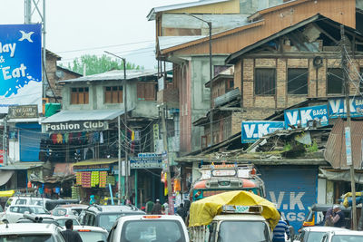 Cars on street against buildings in city