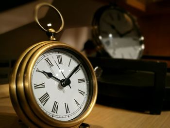 Close-up of clock on table