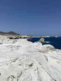 Scenic view of sea against clear blue sky