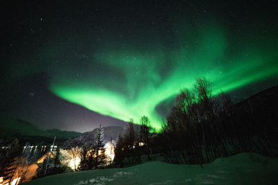 Scenic view of snowcapped mountains against sky at night