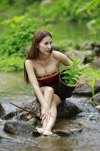 Young woman sitting in water