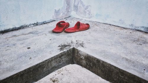 High angle view of shoes on retaining wall
