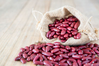 Close-up of kidney beans in sack on table