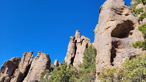 Low angle view of rock formation against blue sky