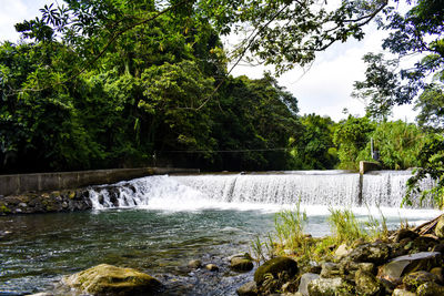 Scenic view of waterfall against sky